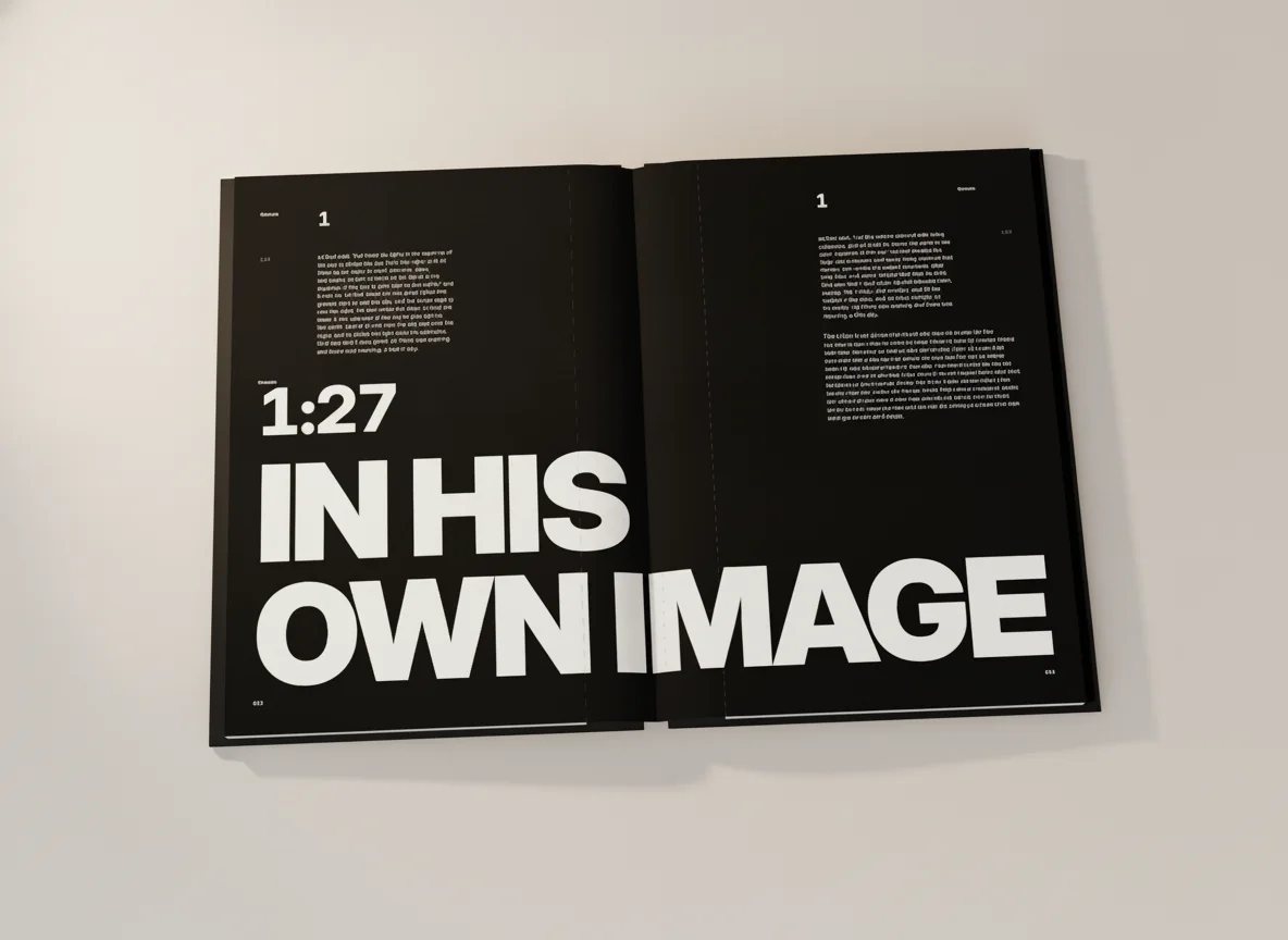 The open Genesis book at the black IN HIS OWN IMAGE spread